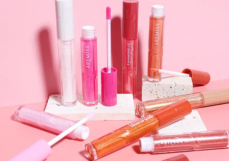 Compact lip gloss tubes in a makeup bag